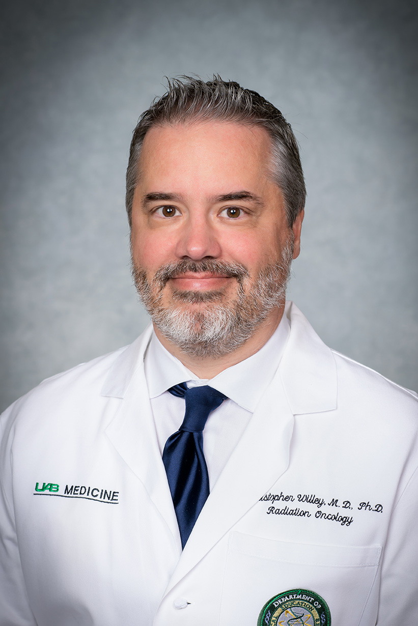 Headshot of Dr. Christopher Willey, MD (Professor, Radiation Oncology) in white medical coat, October 2022.