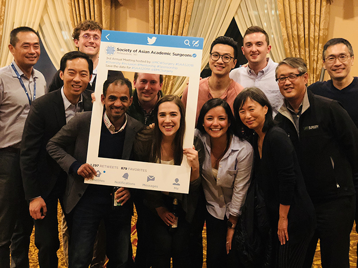 UAB Department of Surgery faculty and trainees pose for a photo using the Society of Asian Academic Surgeons' Twitter photo prop at the Society's annual meeting, hosted by the Medical College of Wisconsin, Sept. 27-28, 2018, in Milwaukee. 