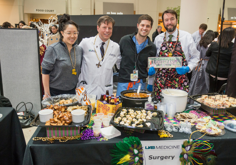The UAB Department of Surgery's Meixi Ma, M.D., Robert Dabal, M.D., Brett Melnikoff, M.D., and Adam Beck, M.D., showed off their Louisiana cuisine at this year's winning table at the 2018 Diversity Fair.