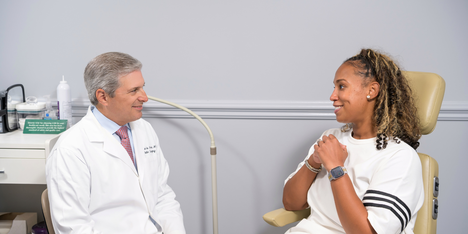 Professor and Division Director Dr. Jorge de la Torre talks with a patient at The Kirklin Clinic.