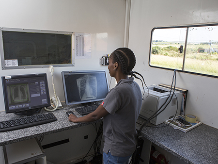 Woman looking at chest X-ray on computer