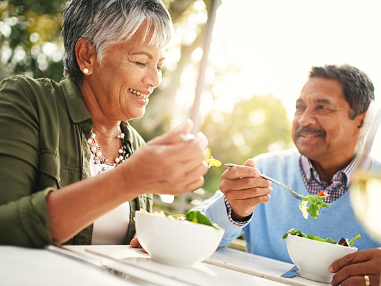 Shot of a happy older couple enjoying a healthy lunch together outdoors