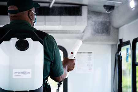 Kevin Flowers sanitizes a UAB bus, moving back to front and spraying a sanitizing solution on all surfaces, especially those that are high-touch areas