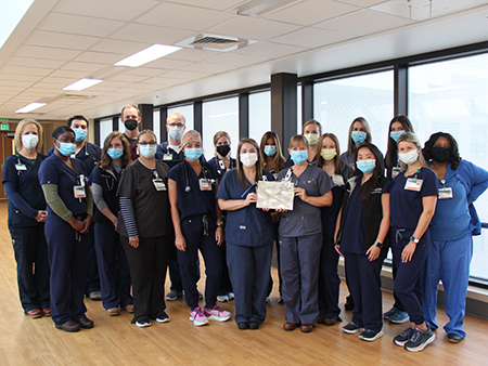 CICU nurses holding award plaque. 