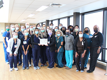 CICU nurses holding Beacon Award plaque. 