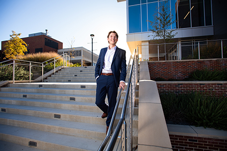 David Russell walks down the steps outside of the SEC.