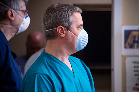 From side, Dr. Dak Shapshak, MD (Associate Professor, Emergency Medicine) and Dr. Christopher Willey, MD (Professor, Radiation Oncology) are both wearing PPE (Personal Protective Equipment) face masks while attending a demonstration for testing the fit of PPE gear at the UAB Hospital COVID-19 (Coronavirus Disease) Command Center in the North Pavilion on April 7, 2020.