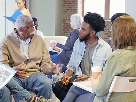 A multi-ethnic, multi generational group openly discusses the racial issues dividing their community.