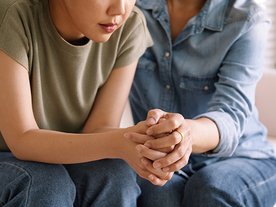 two females holding hands