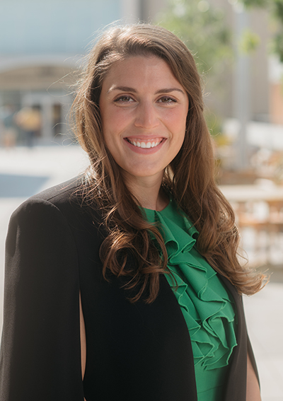 Headshot of Tara Kelly in a green blouse and black blazer.