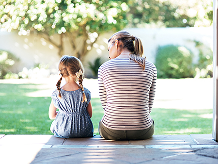 Rearview shot of a young woman and her daughter having a conversation on the porch