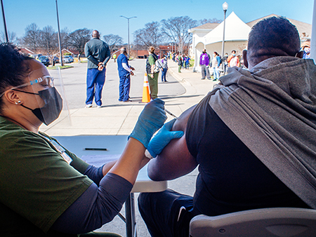 A patient leaves after their 15 minute observation period