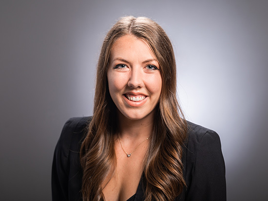 Headshot of UAB professor, Rachel Smith, on a neutral background, dressed in a black blazer. 