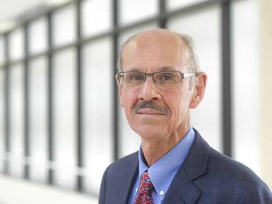 Close-up of Dr. Sadis Matalon, PhD (Professor, Anesthesiology) standing in interior crosswalk, 2013.