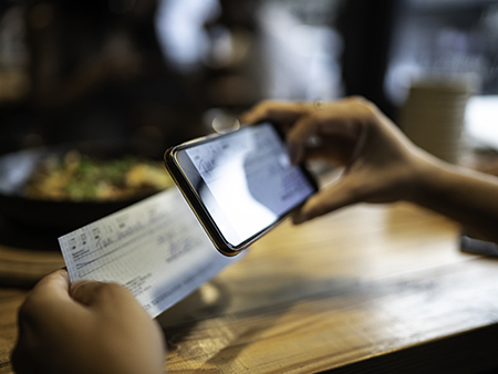 Man depositing check by phone in the restaurant