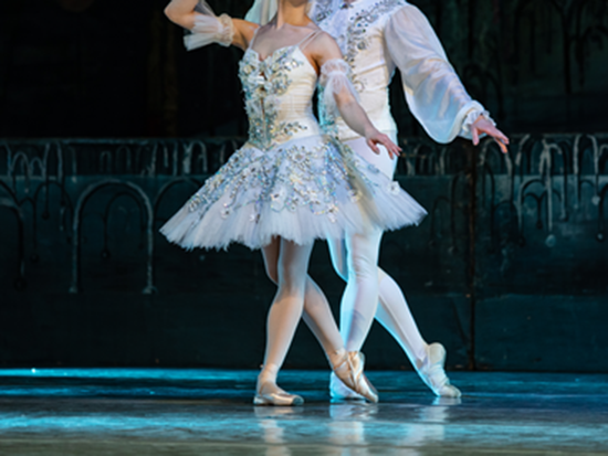 Ballerinas performing on a stage.