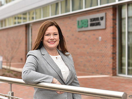 Michele Talley standing in front of building at UAB. 