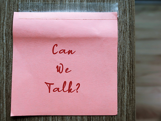 Pink note on wood walll with text written CAN WE TALK , concept of talk openly to improve relationship, listen and share more, for couples or for teamwork