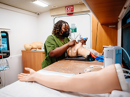 Health care worker practicing intubating a patient 