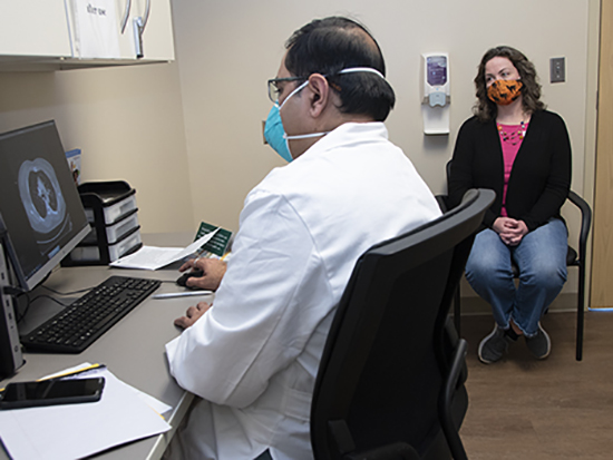 Sick woman in quarantine talking with her doctor online using a tablet computer - healthcare concepts