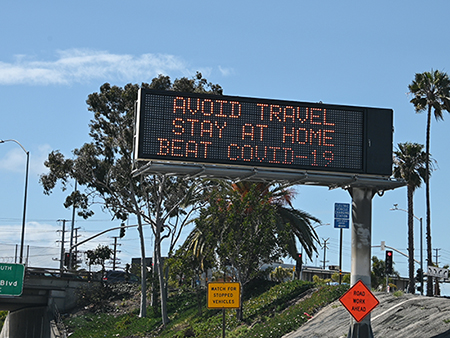 Highway digital signs display messages about stay home and avoiding travel during an outbreak of the COVID-19 coronavirus, Los Angeles, California, March 25, 2020.