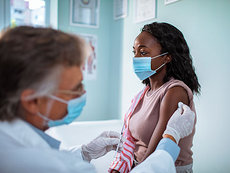 Close up of a young woman getting vaccinated