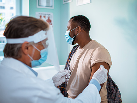 Close up of a young man getting vaccinated