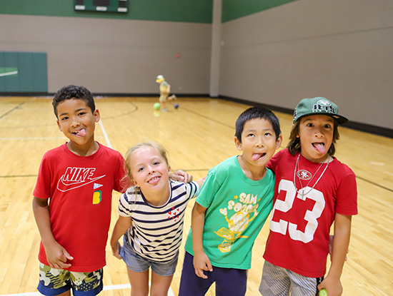 Four children posing in a UAB Recreation Center court