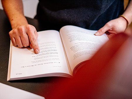 Hands are holding an open book, 2018.