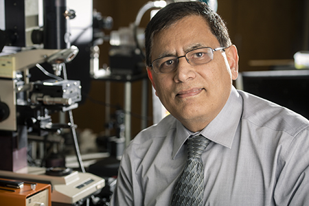 Environmental shot of Dr. Yogesh Vohra, PhD (Professor/Associate Dean, Physics) is conducting research to study materiala under extreme conditions of pressures nad temperatures using the nanocrystalline diamond built by vapor deposition in his laboratory, 2018.