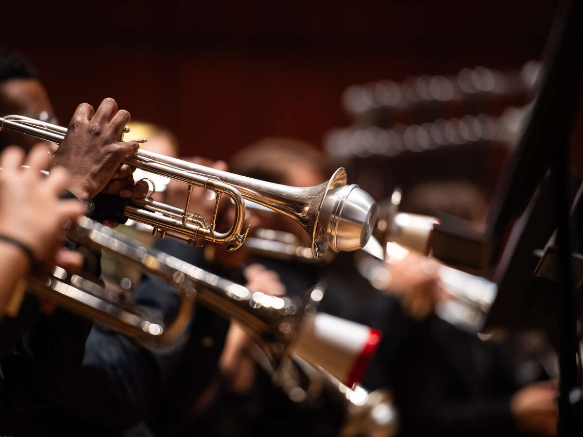 2024 UAB Symphony Band Rehearsal, Alys Stephens Center - Jemison Concert Hall.  From side, hands of several student musicians are playing trumpets while seated on stage, November 2024.