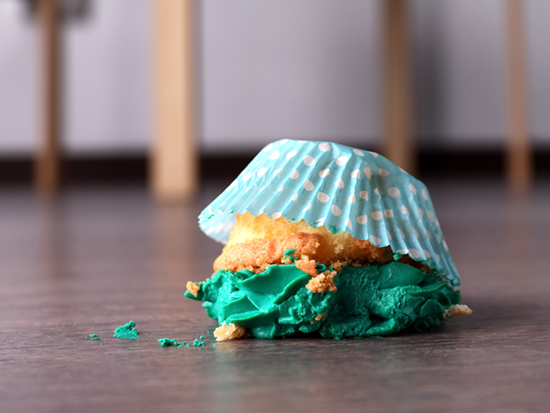 Green cupcake on floor