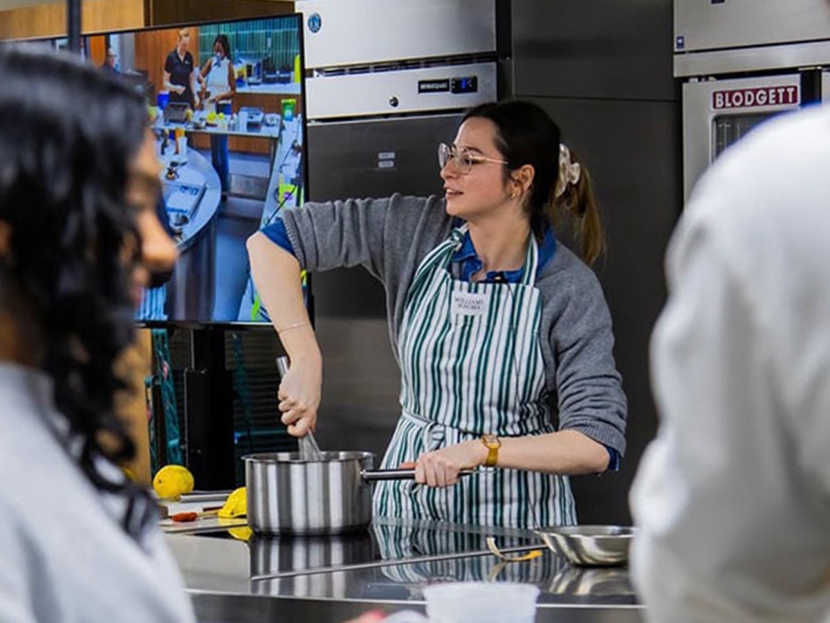 A teacher stirs filling for a classic tarte au citron, or lemon tart, for the class.