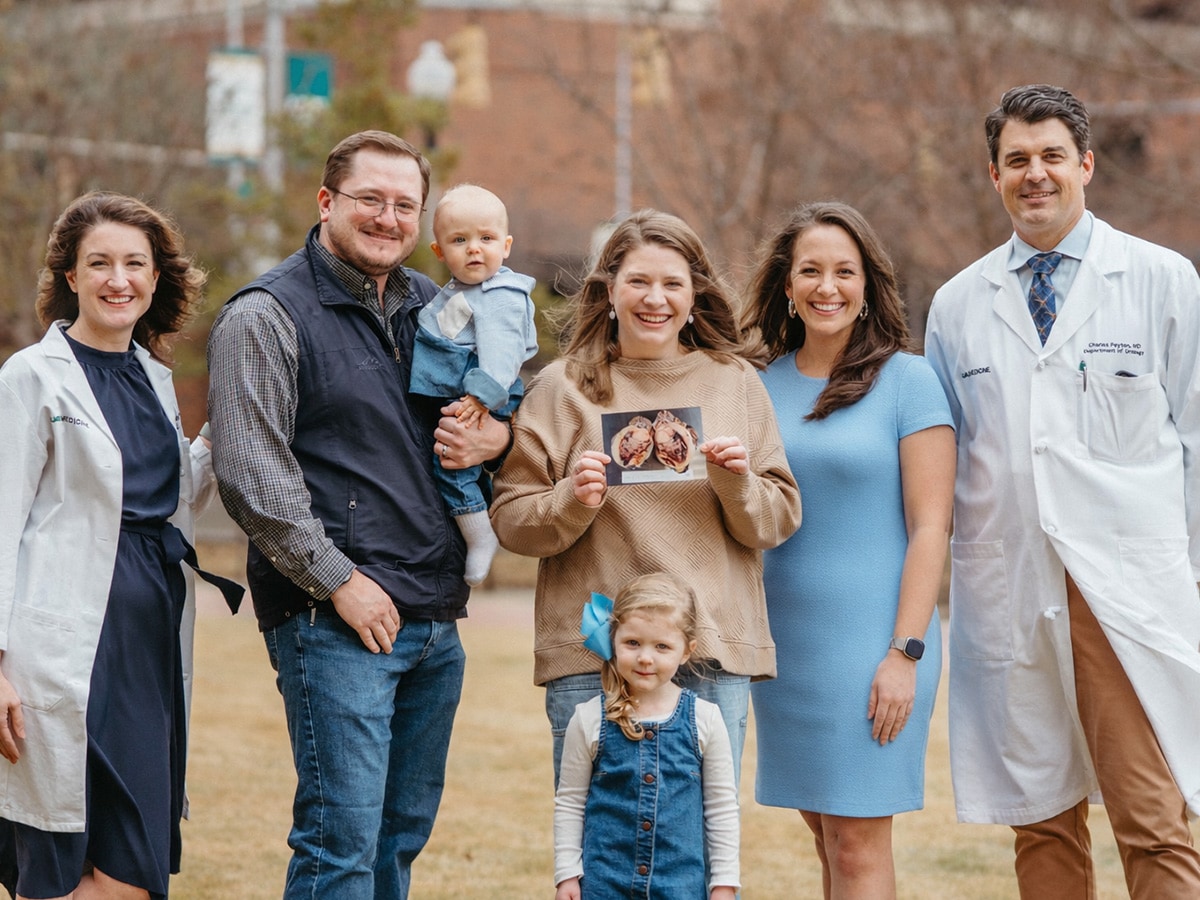 Heidi Neas posing with her family and physicians.