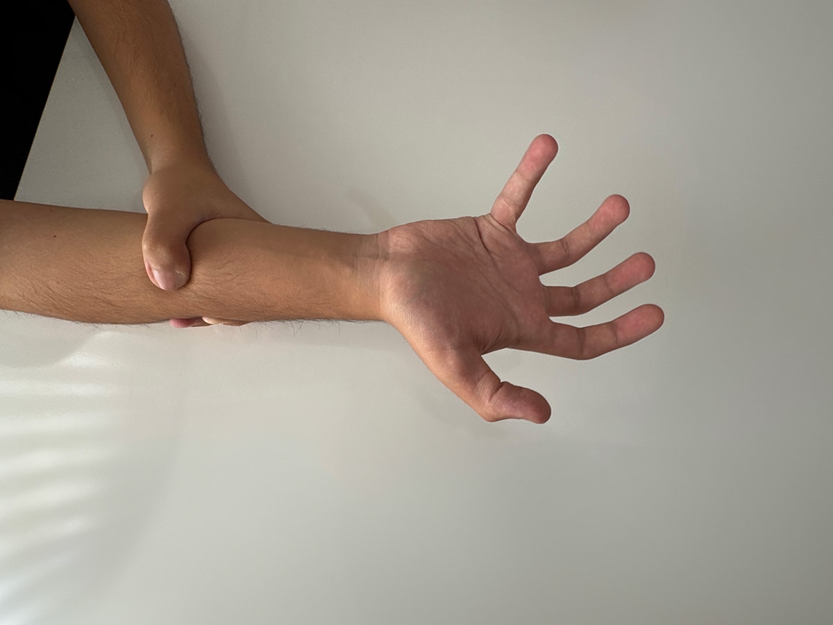 Person attempting to control right hand by grabbing it with their left hand.