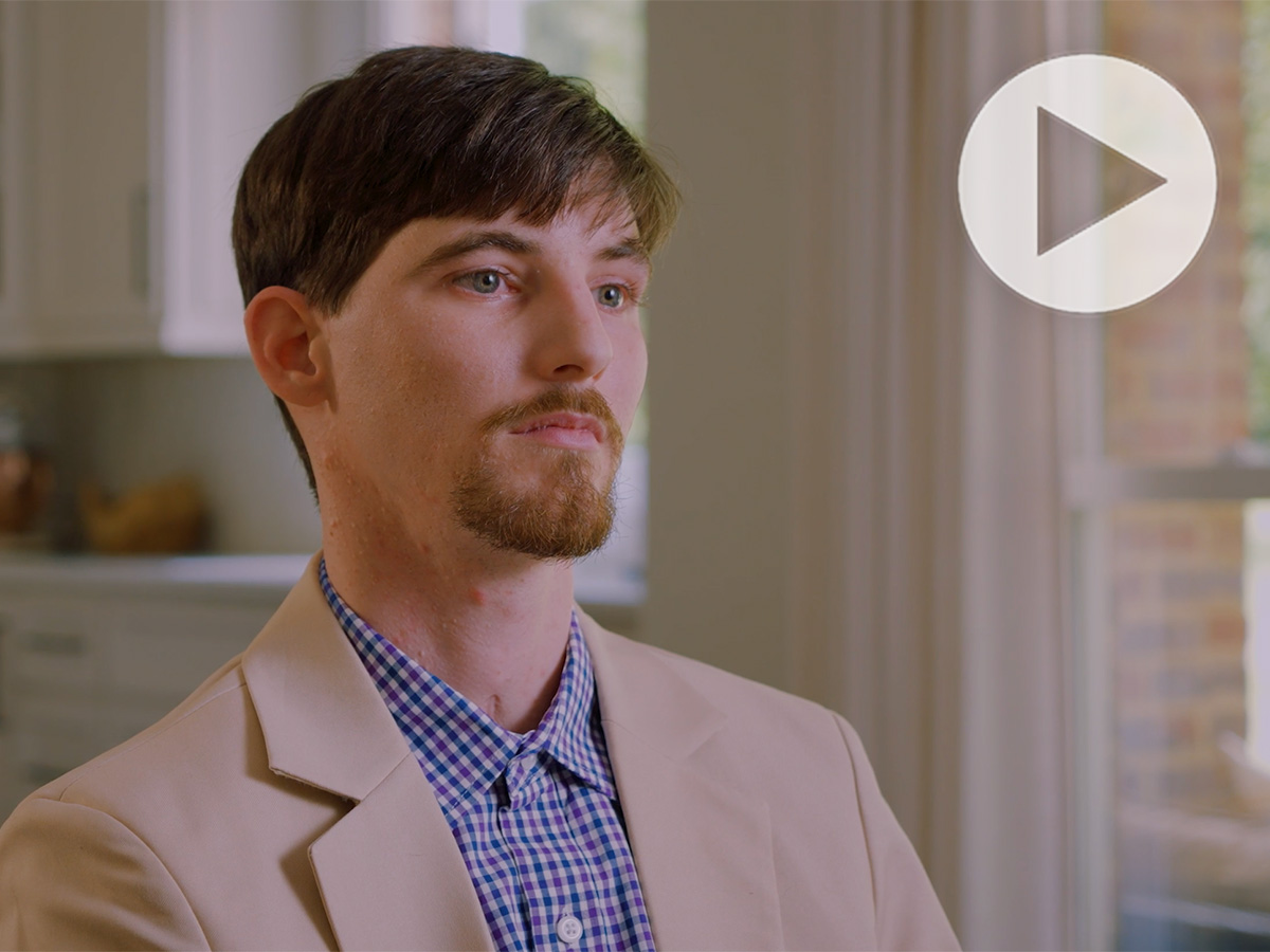 Jacob Smith in beige blazer and blue striped shirt.