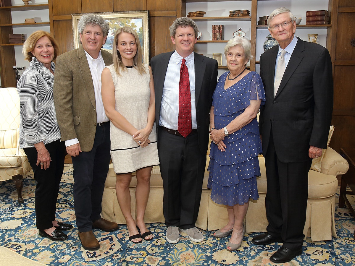 The Goodrich family standing for a portrait in an indoor setting