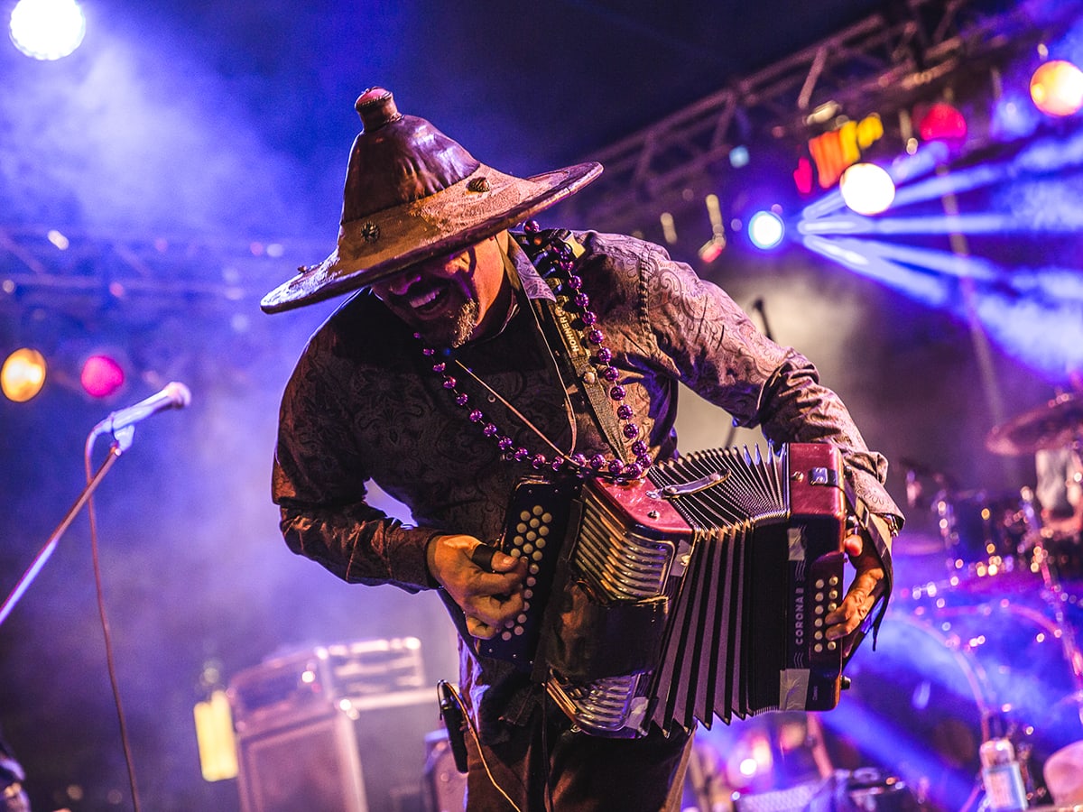 Terrance Simien on stage playing an instrument