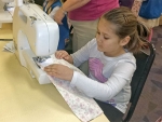 Handmade baby quilts sewn by Girl Scout troop donated to UAB’s neonatal intensive care unit