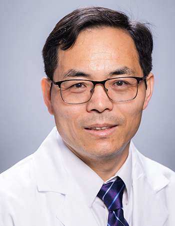 Headshot of Dr. Lewis Shi, PhD (Associate Professor, Radiation Oncology - Preclinical Research) in white medical coat, September 2022.