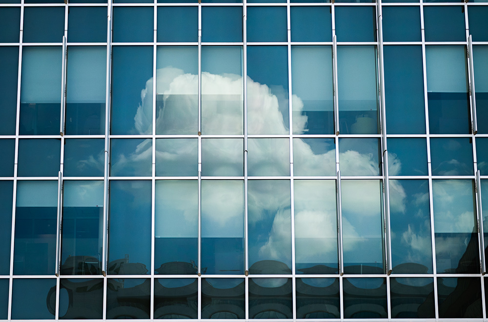 Clouds reflected in the windows of the School of Nursing