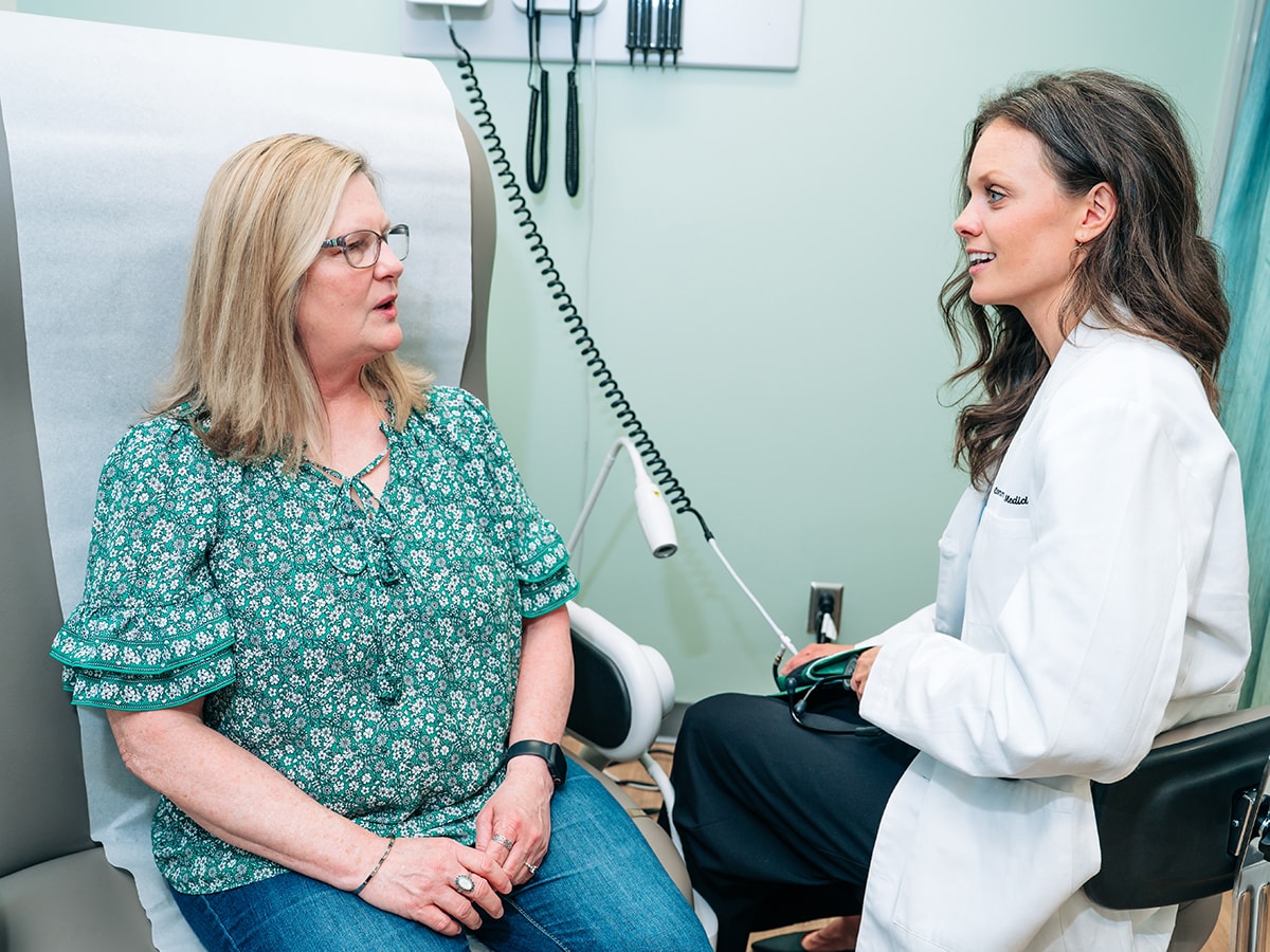A doctor and patient talk in a UAB clinic room