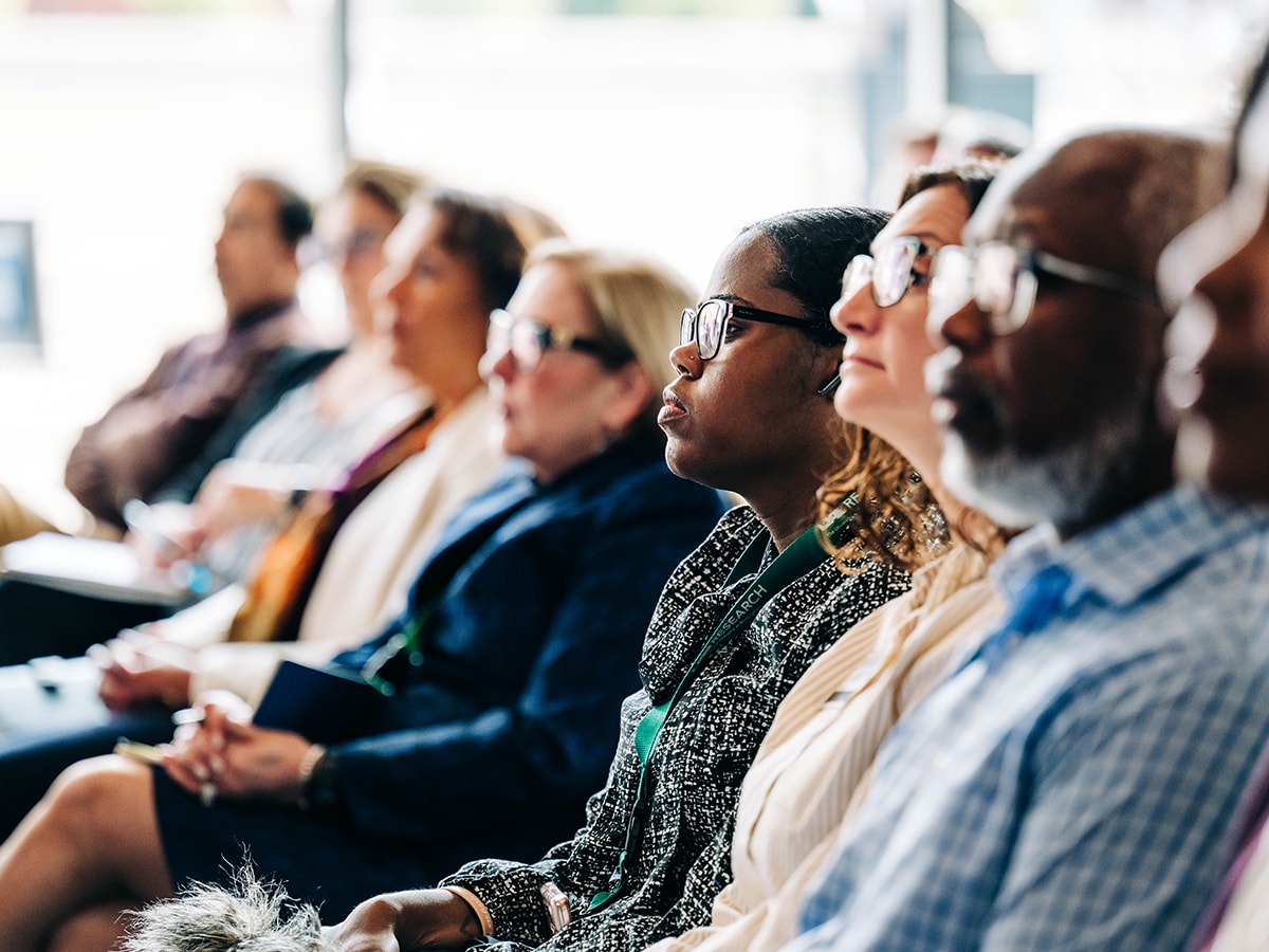 View down a row of attendees as they listen to a speaker off camera at the Research Strategic Initiative town hall on March 19, 2026