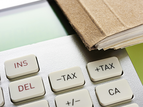 Calculator and ballpoint pen. Top view focus in tax.