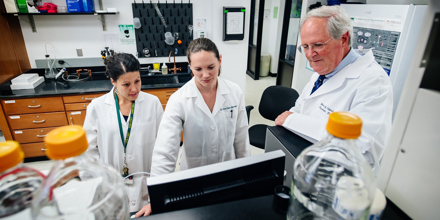 A female UAB student performing research in a lab supervised by a faculty member.