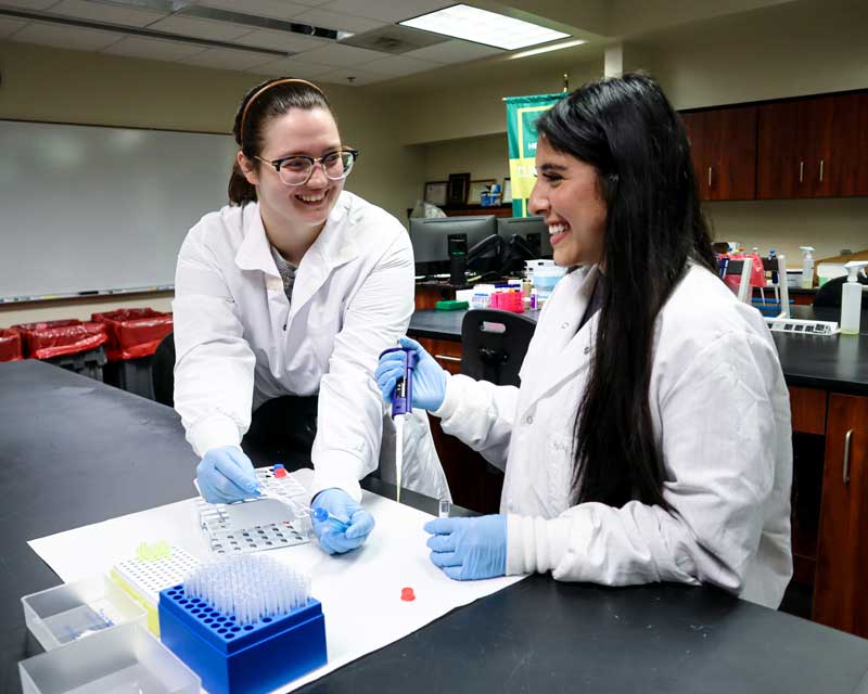 Two students working in a laboratory.