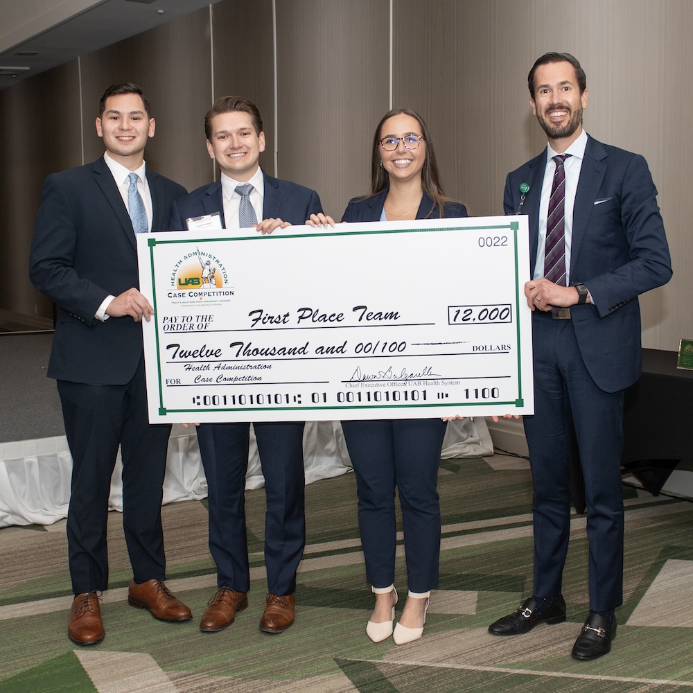 Team holding giant check at 2023 competition. 