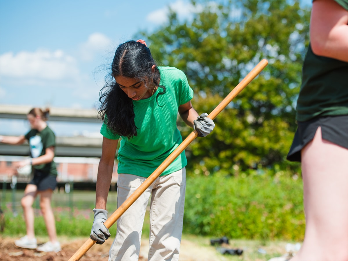 A volunteer working at a community garden