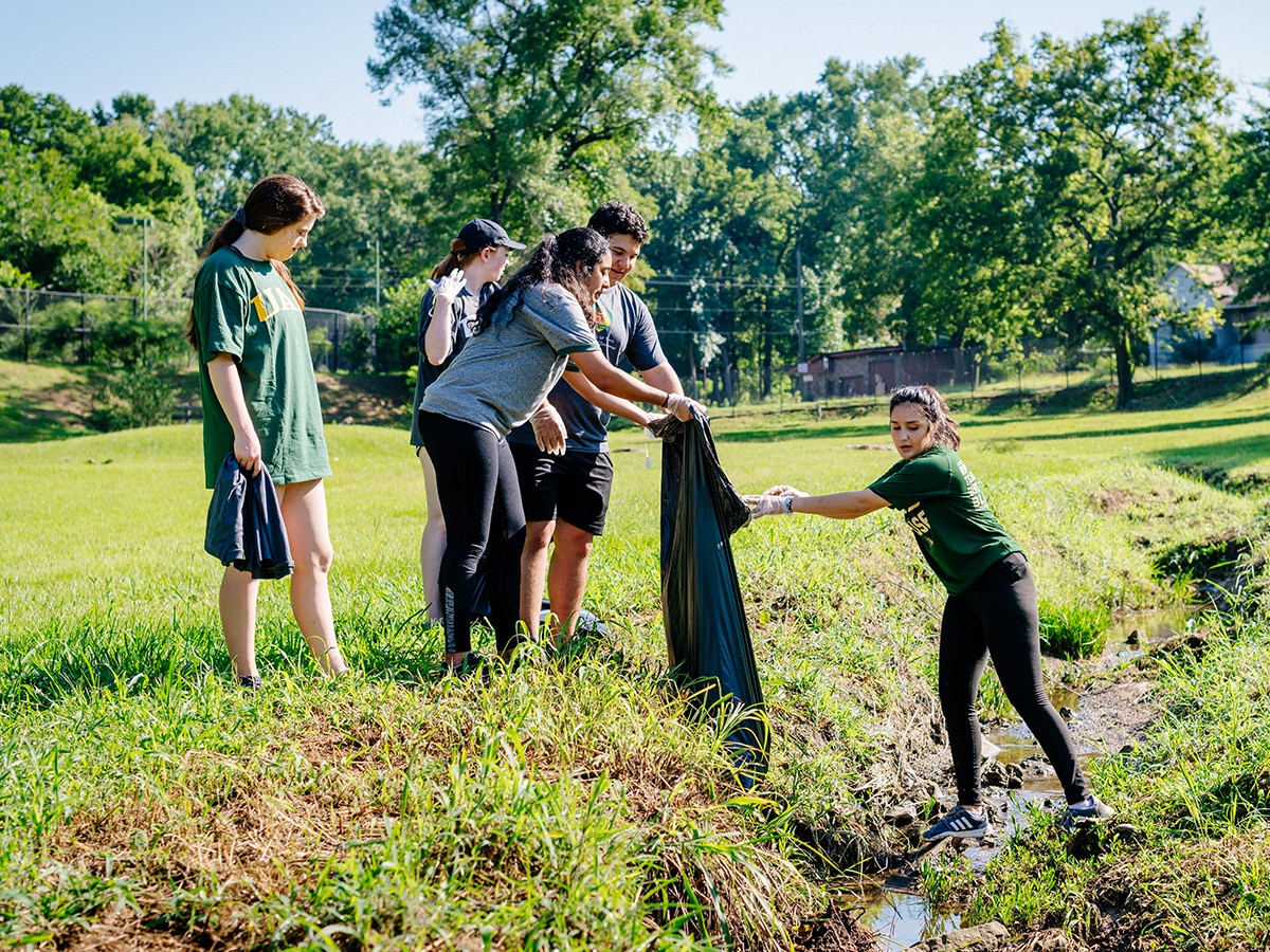 Student volunteers cleaning up a stream