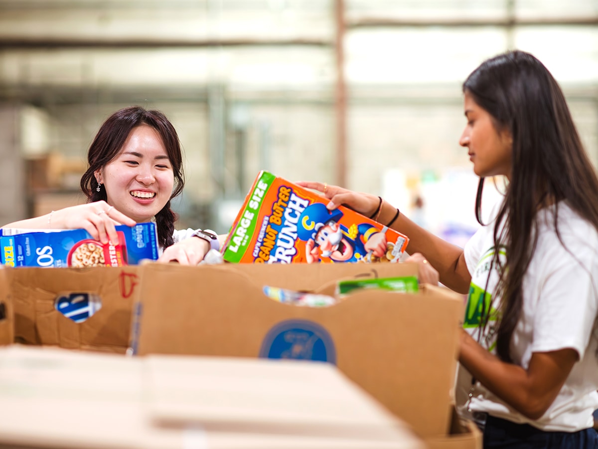 Student volunteers sorting items at a food pantry